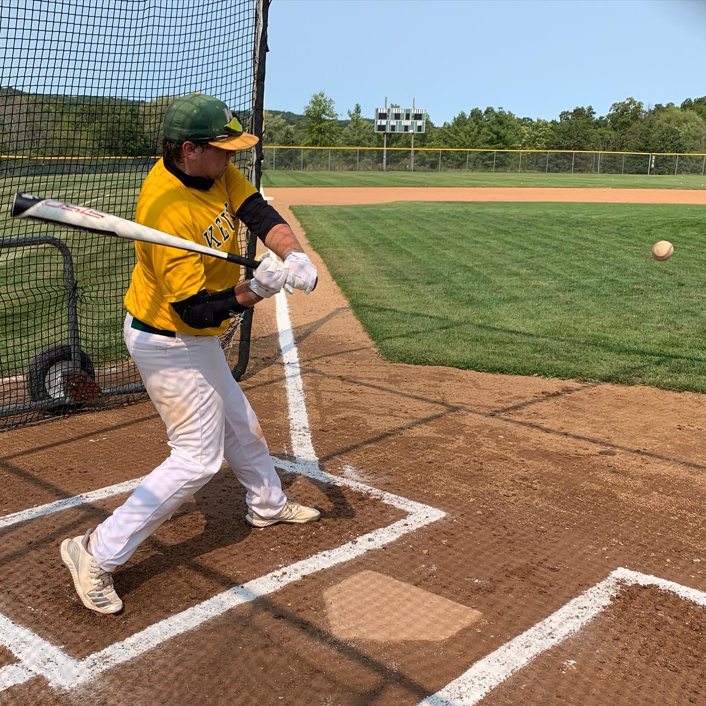 KC Baseball player hitting a ball on home plate